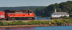 NR-2s trailing power rolls along Mill Cove with the Harvard Boat House in the background