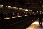 Passengers wait for their train