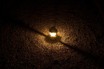 A lantern sits on the stone driveway