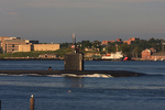 A US Navy Los Angeles class fast attack submarine heads north in the Thames River with the USCG base in the background A US Navy Los Angeles class fast attack submarine heads north in the Thames River with the USCG base in the background