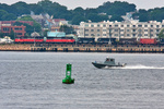 A US Navy Police boat speeds past NR-2